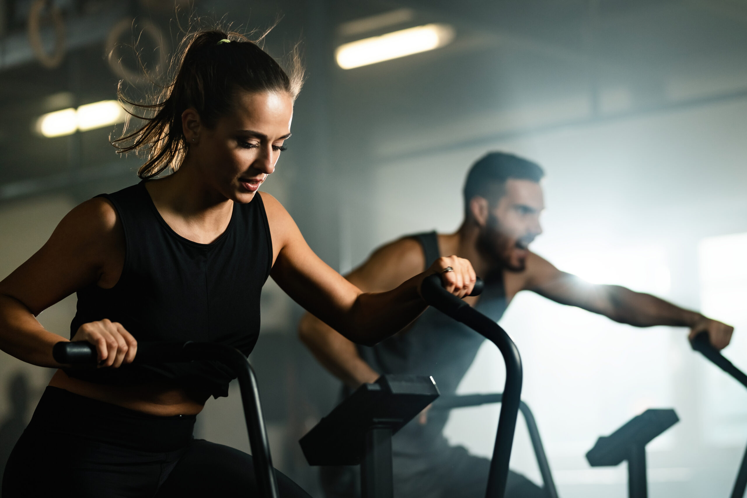Man and woman doing cardio conditioning workout as part of a structured weekly training split.